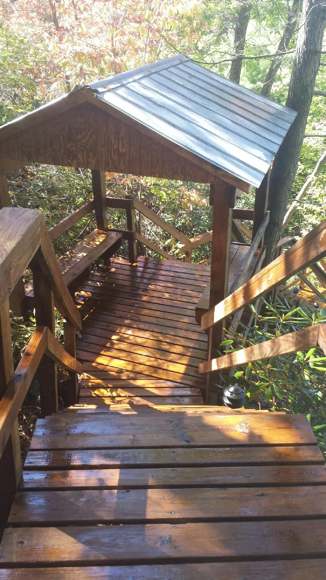 Freshly stained wood walkway and covered shelter with a metal roof in Maupin
